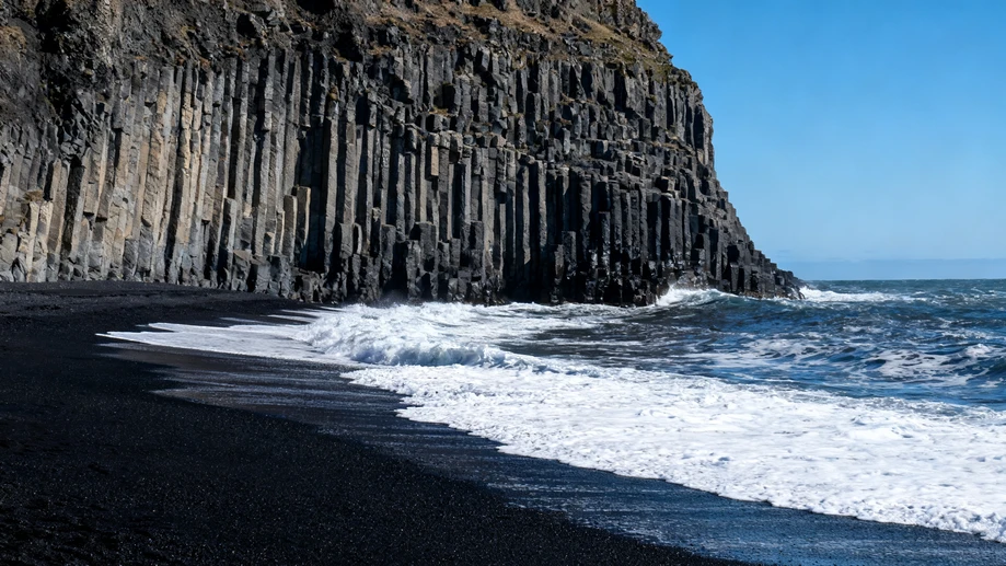 Stroll Along Iceland’s Stunning Jet-Black Volcanic Shores Under the Gentle Bright Glow of Arctic Sunlight